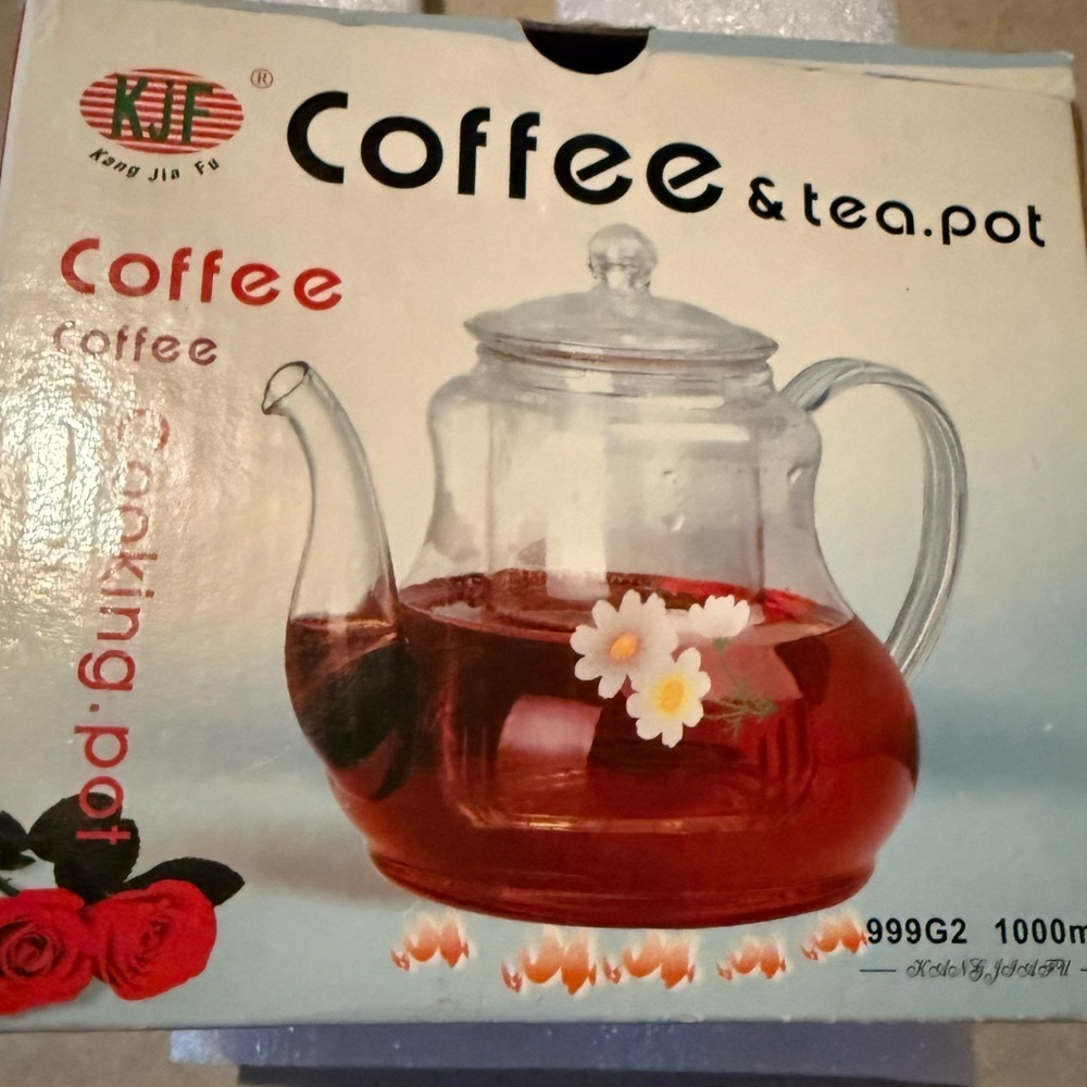 Glass tea pot about 6 inches tall including the lid has decorative yellow flower